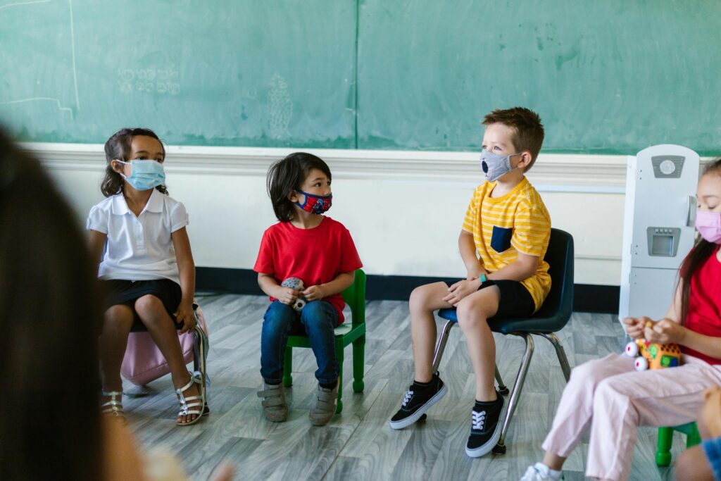 Children in a class with masks